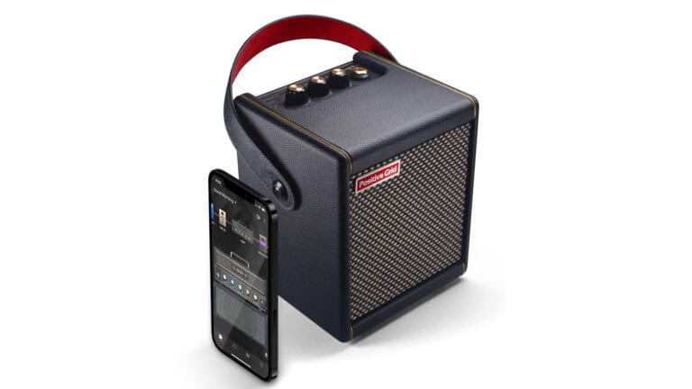 positive grid spark mini stereo mini amplifier with black enclosure, gray grill cloth, and travel handle