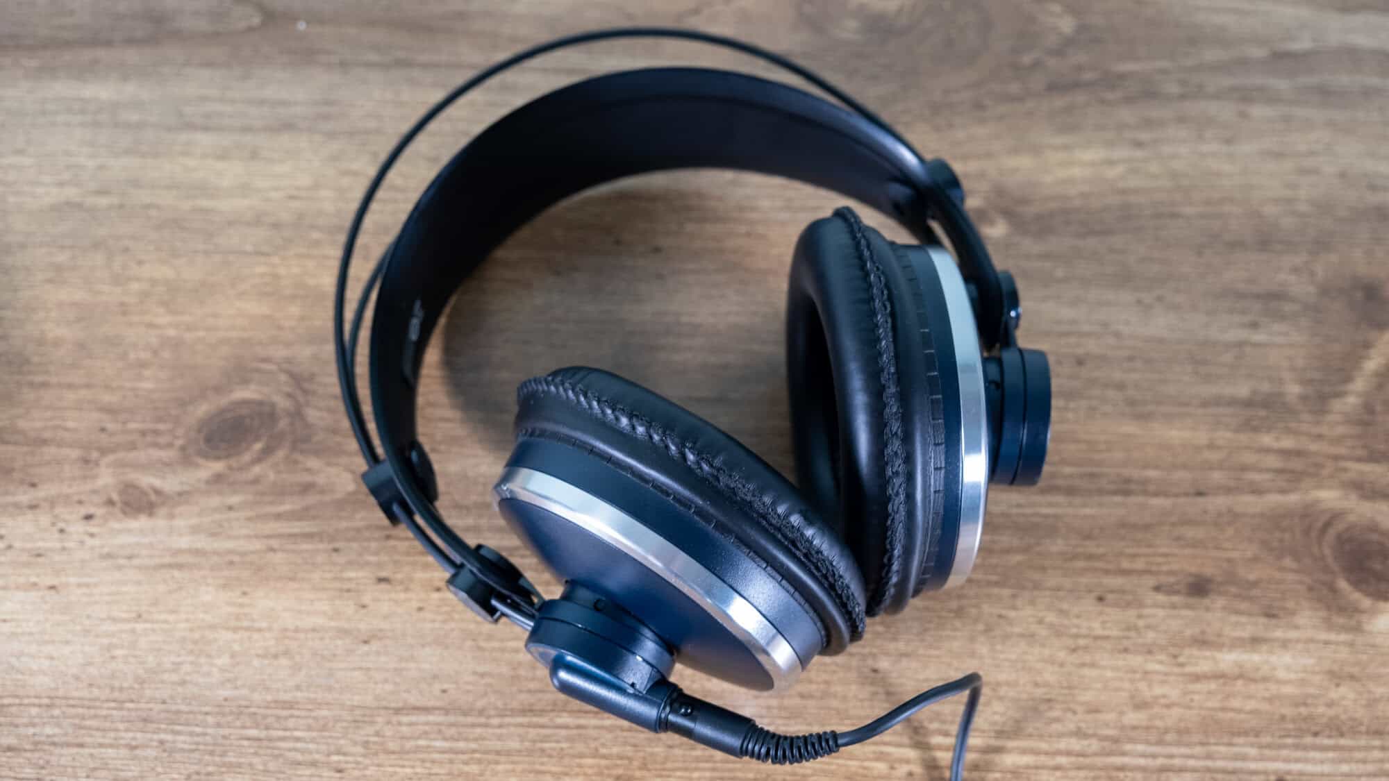 Looking down at the AKG K271 MKII headphones on a wooden table.