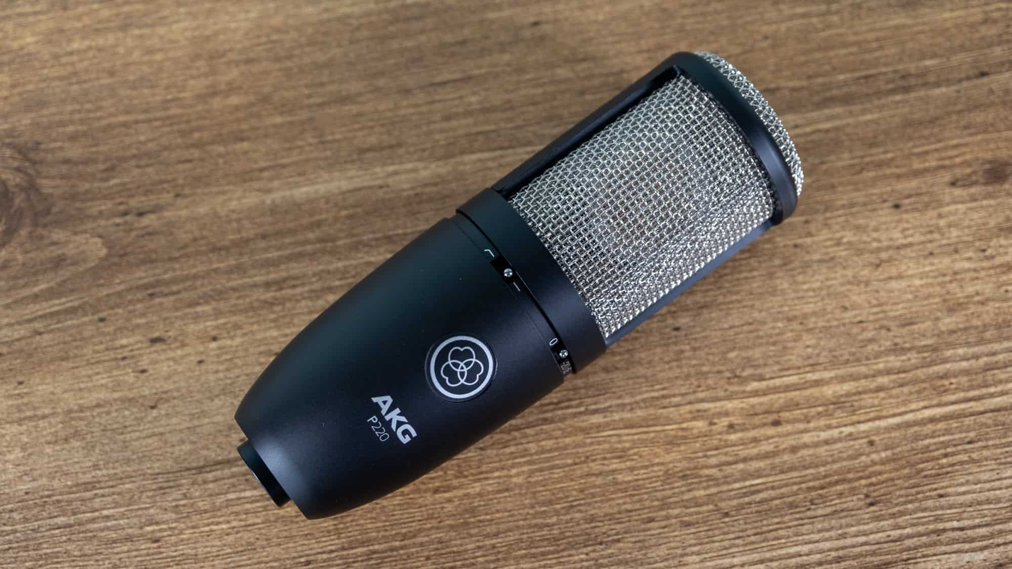 AKG P220 microphone on a wooden table.