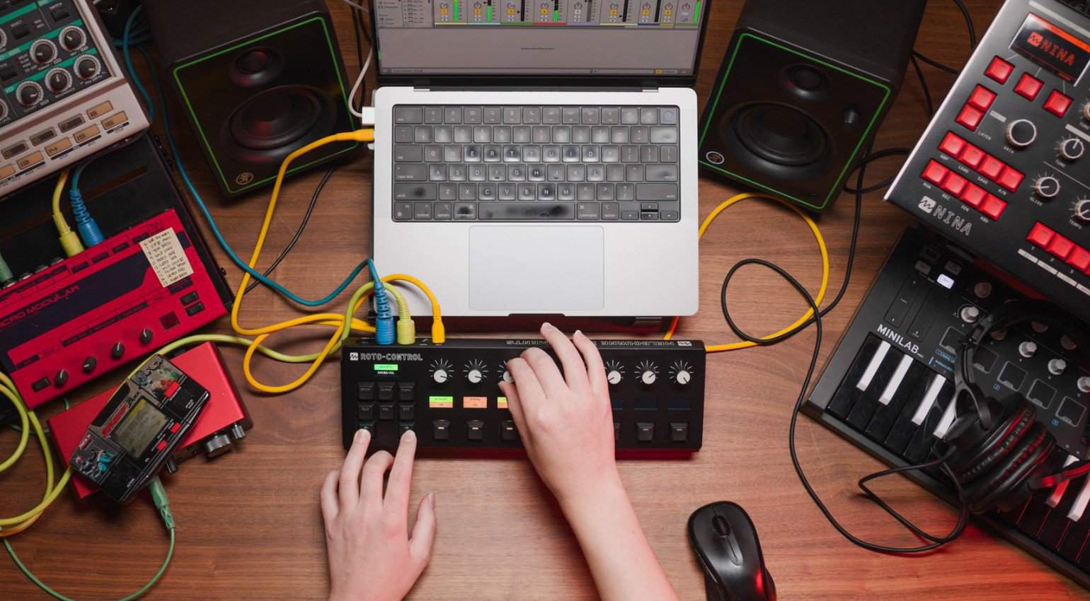 Person using the Melbourne Instruments Roto-Control, surrounded by a computer and other devices.