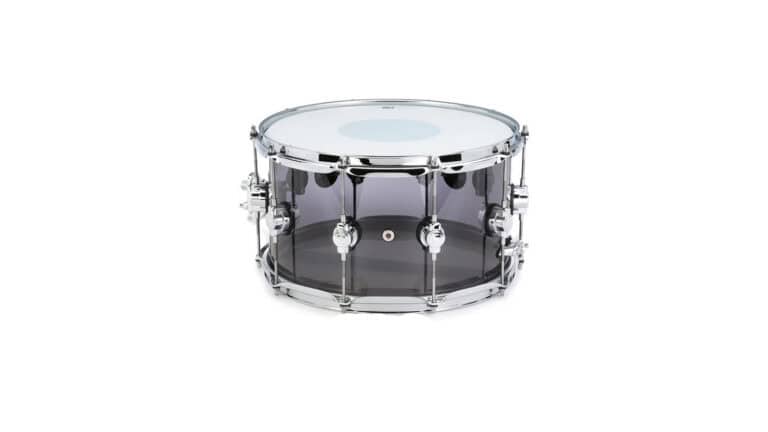 DW Design Series Acrylic Snare Drum side shot with see-through shell, drumheads, and hardware